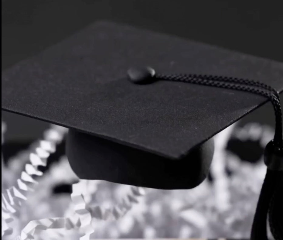 Elegantly curated ekuBOX graduation gift box with handwritten note, artisanal treats, and premium accessories arranged on a styled surface