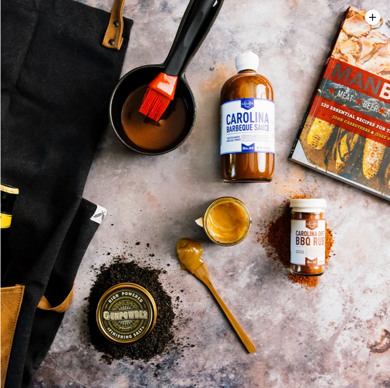 ekuBOX Grill Masters BBQ Gift Box open and styled with premium BBQ sauces, rubs, and gourmet grilling essentials