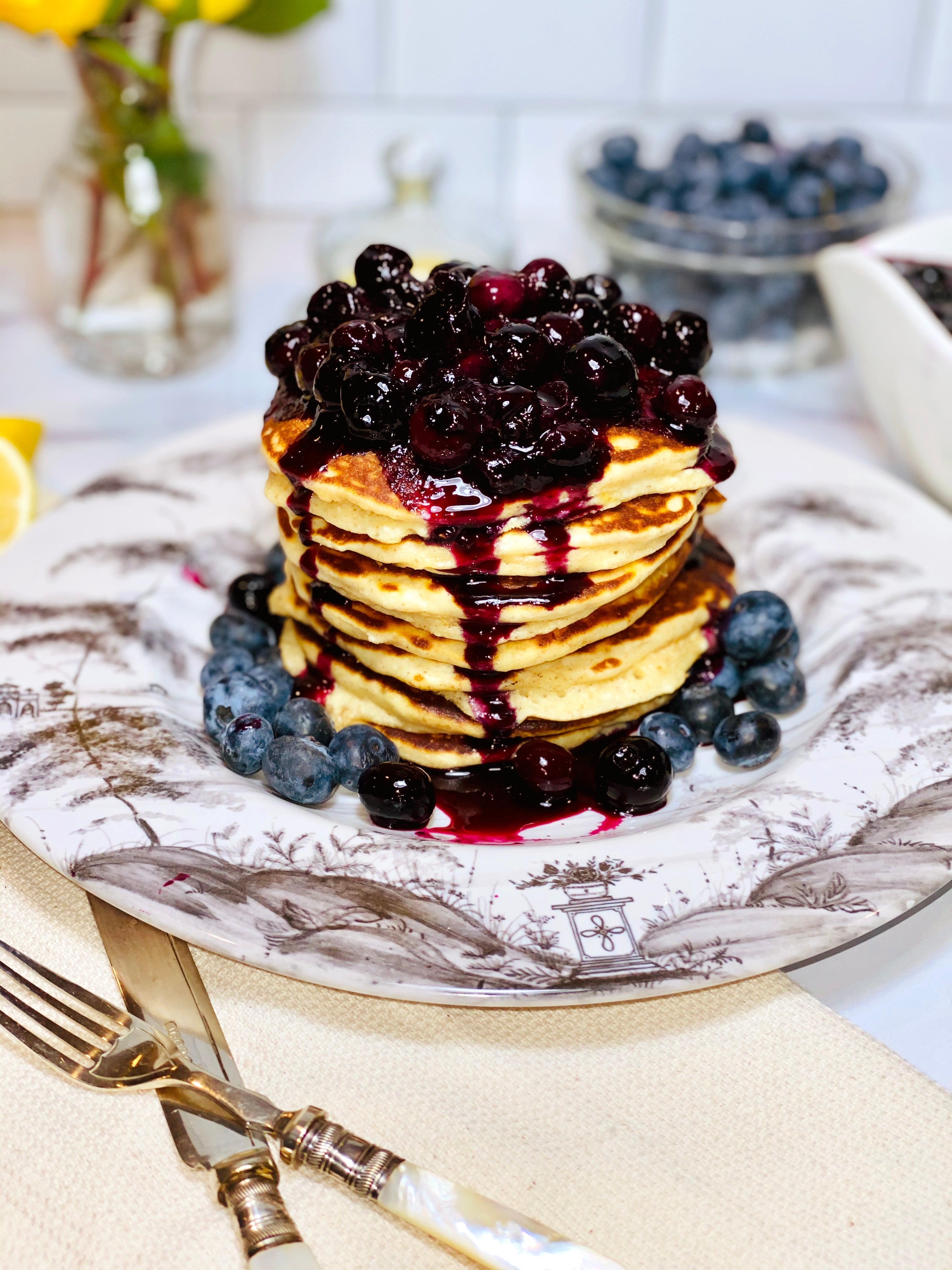 Fluffy lemon ricotta pancakes topped with fresh blueberry sauce — a gourmet brunch recipe from ekuBOX