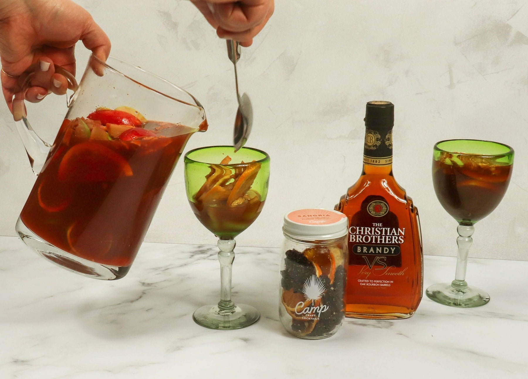 A pitcher of classic Spanish-style sangria with red wine, fresh citrus, and berries — recipe from ekuBOX Spanish Paella & Tapas Gift Box