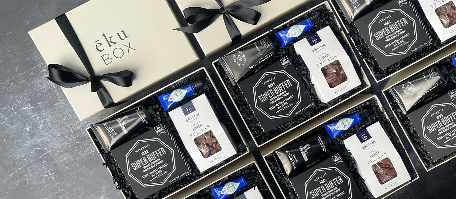 A row of identical men’s grooming gift boxes with coordinated packaging, prepared for employee appreciation and corporate gifts.