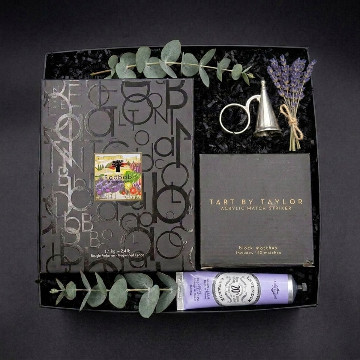 Baobab Gift set with Provence candle in the box, hand cream, Match Pewter snuffer and an acrylic match holder in the box, in a black box on a dark background