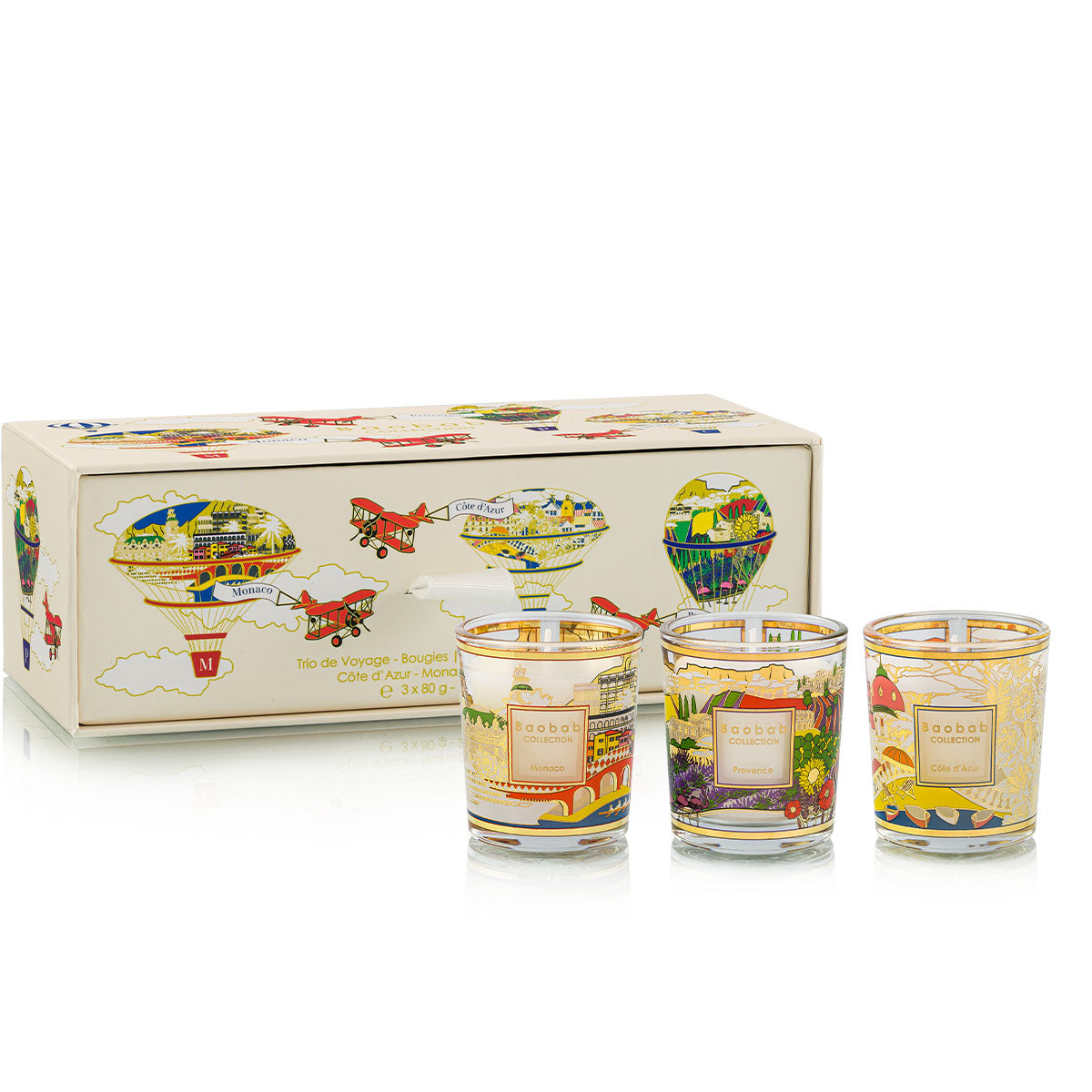 Baobab Collection travel candle trio featuring Côte d’Azur, Monaco, and Provence scents in a cream box with colorful hot air balloon illustrations on a white background.