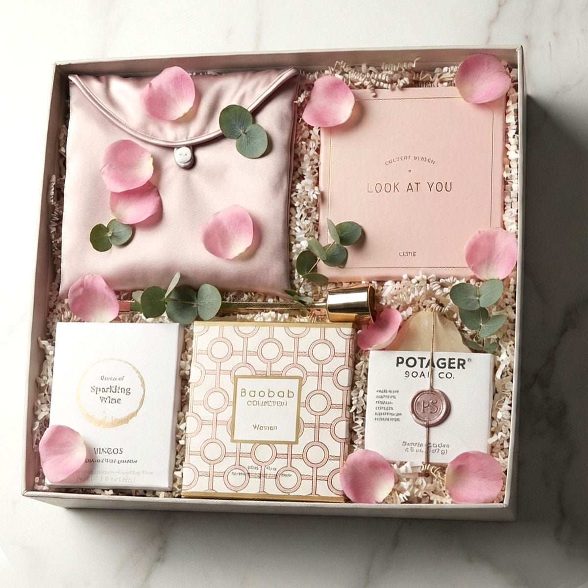 Baobob woman candle gift set with soap, gummies, silk pillow cover, compact mirror, candle snuffer in a gift box with rose petals