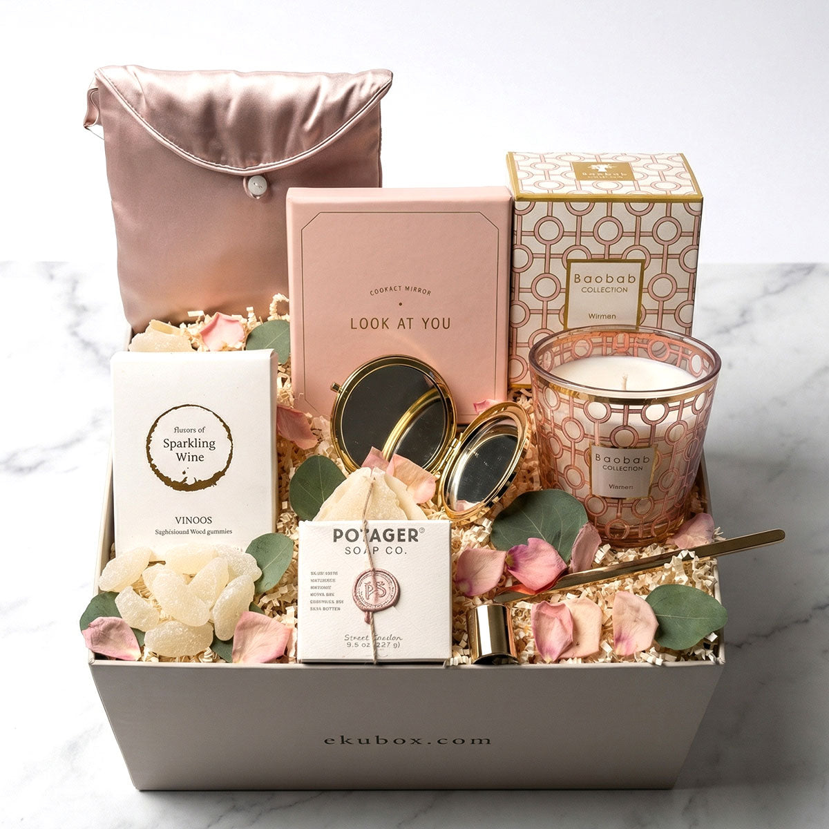 Baobob woman candle gift set with soap, gummies, silk pillow cover, compact mirror, candle snuffer in a gift box.