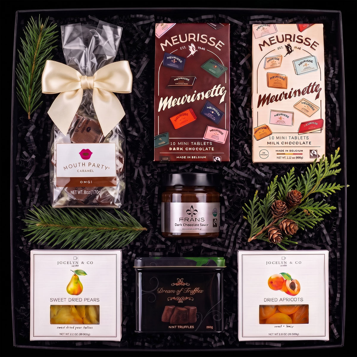 A luxury gift box set that includes a bag of chocolate covered caramels Meurisse dark chocolate mini tablets, Meurisse milk chocolate, a jar of dark chocolate dipping sauce, a box of dried apricots and dried pears, and a tin of chocolate truffles.