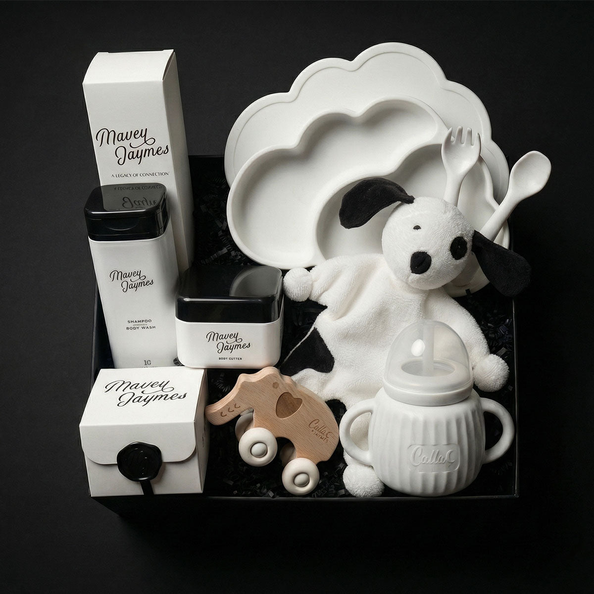 Luxury baby gift box with natural skincare, silicone feeding set, organic cotton toy, and developmental baby toy. A thoughtful gift for newborns and baby showers.