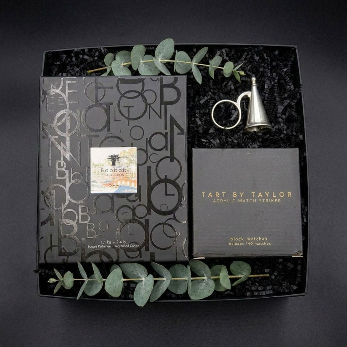 Gift set with match striker, matches, and Baobab Monaco candle all in their boxes with the Match Pewter snuffer in a black box.