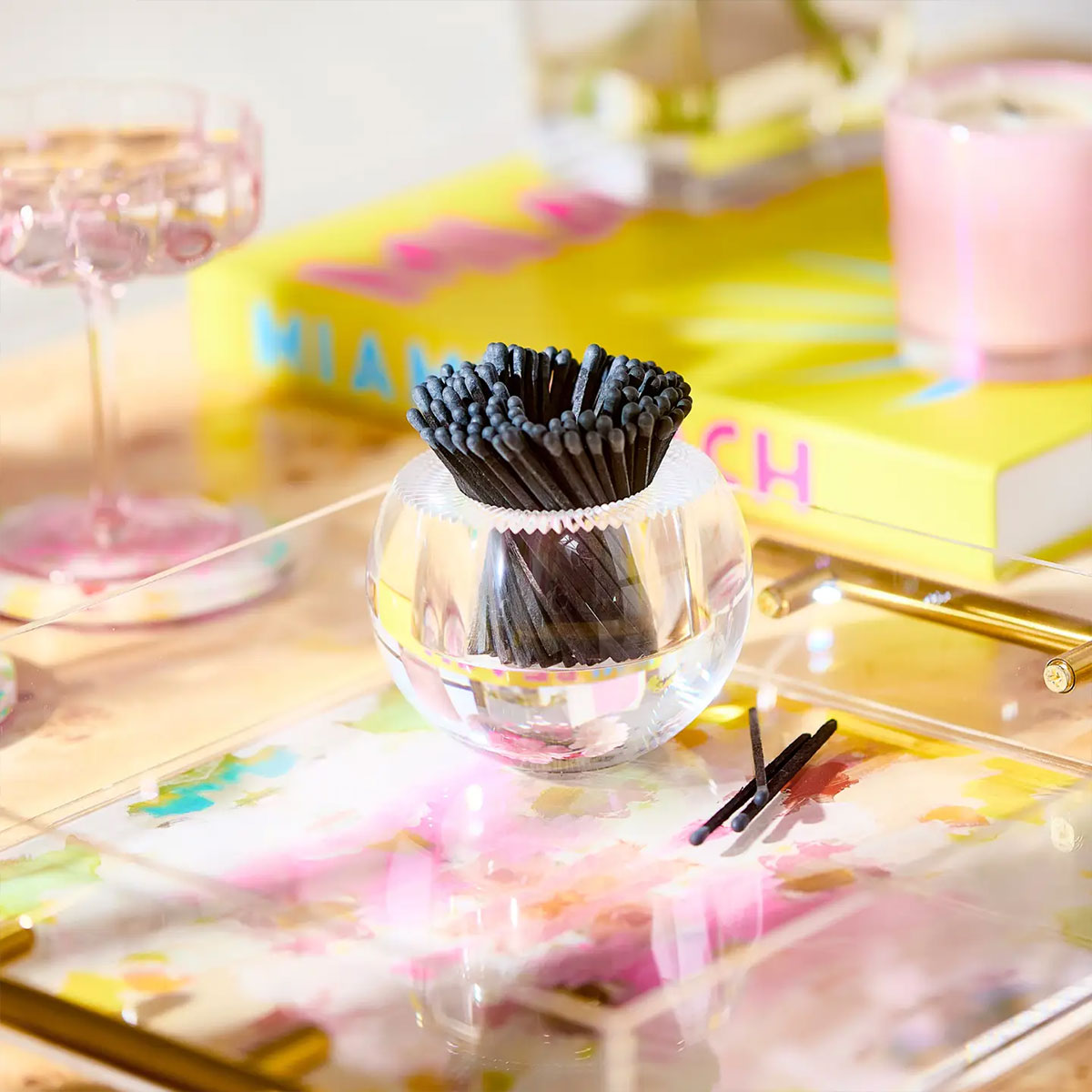 acrylic holder with black matches on an acrylic table