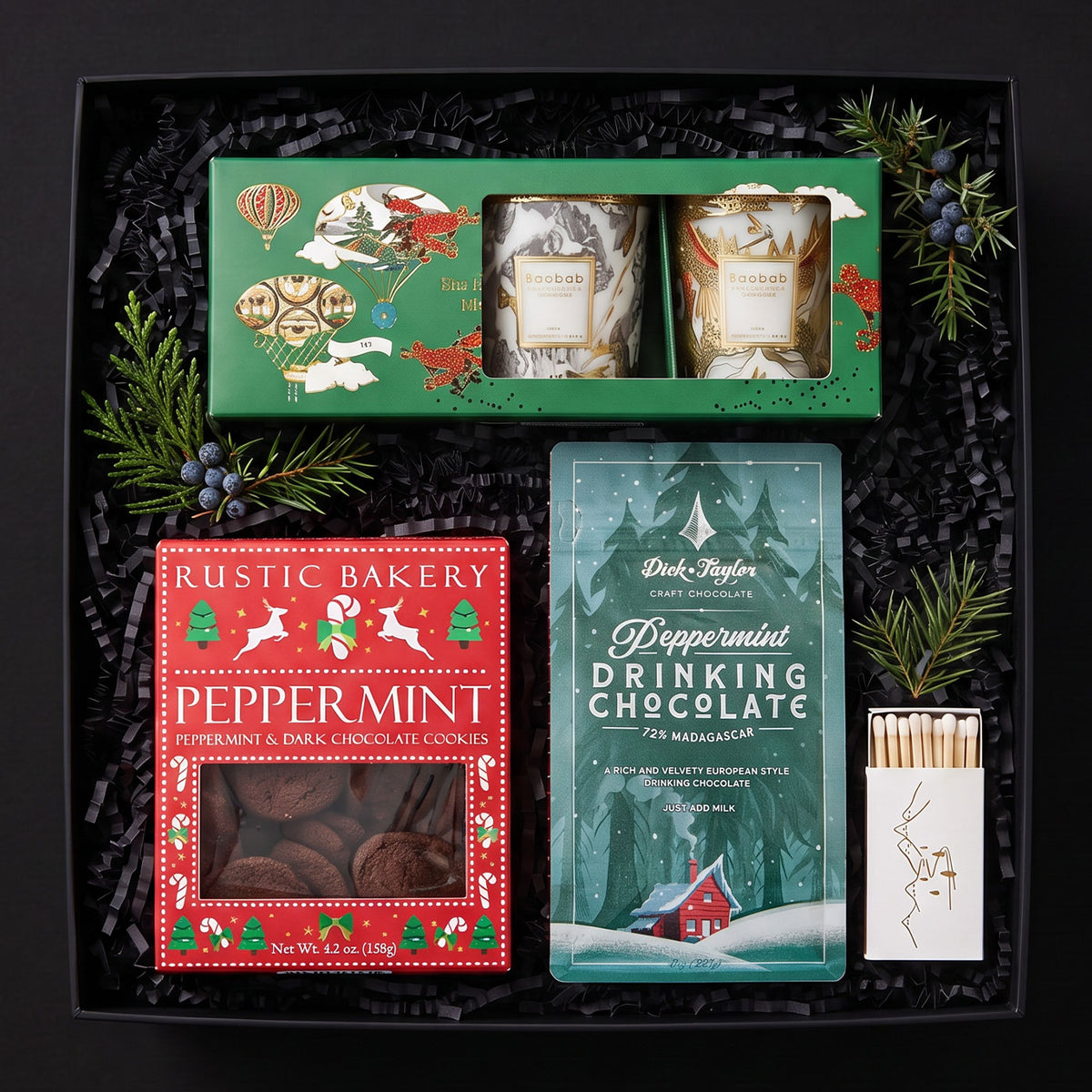 baobab après trio candles, pepperment drinking chocolate by dick taylor, rustick bakery peppermint chocolate cookies, box of matches in a black gift box.