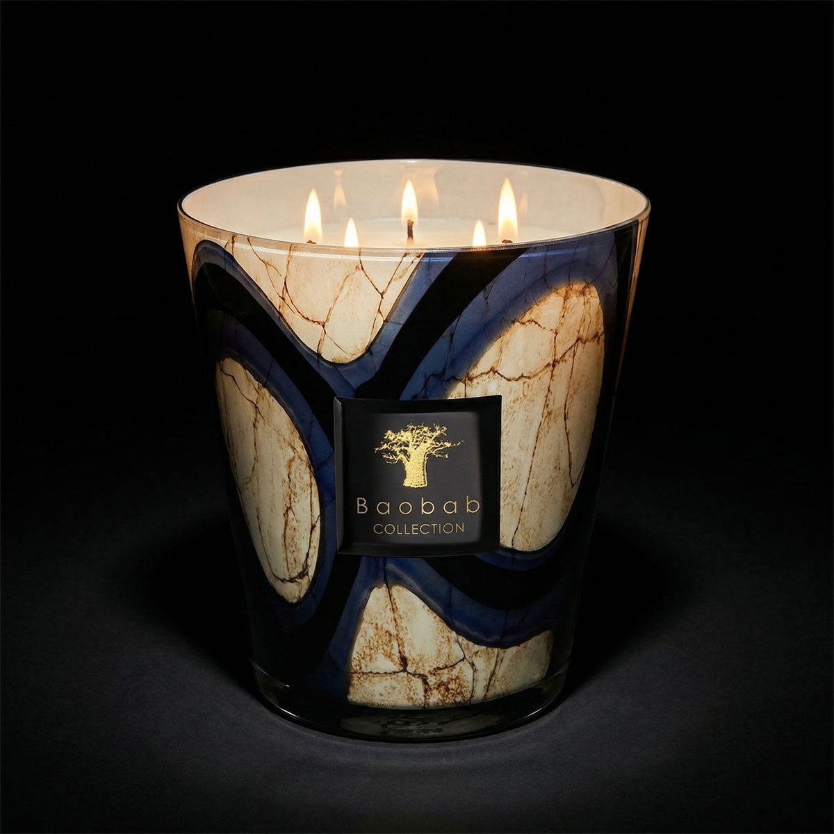 Baobab from the stones collection - Lazuli candle with branding on a dark background.