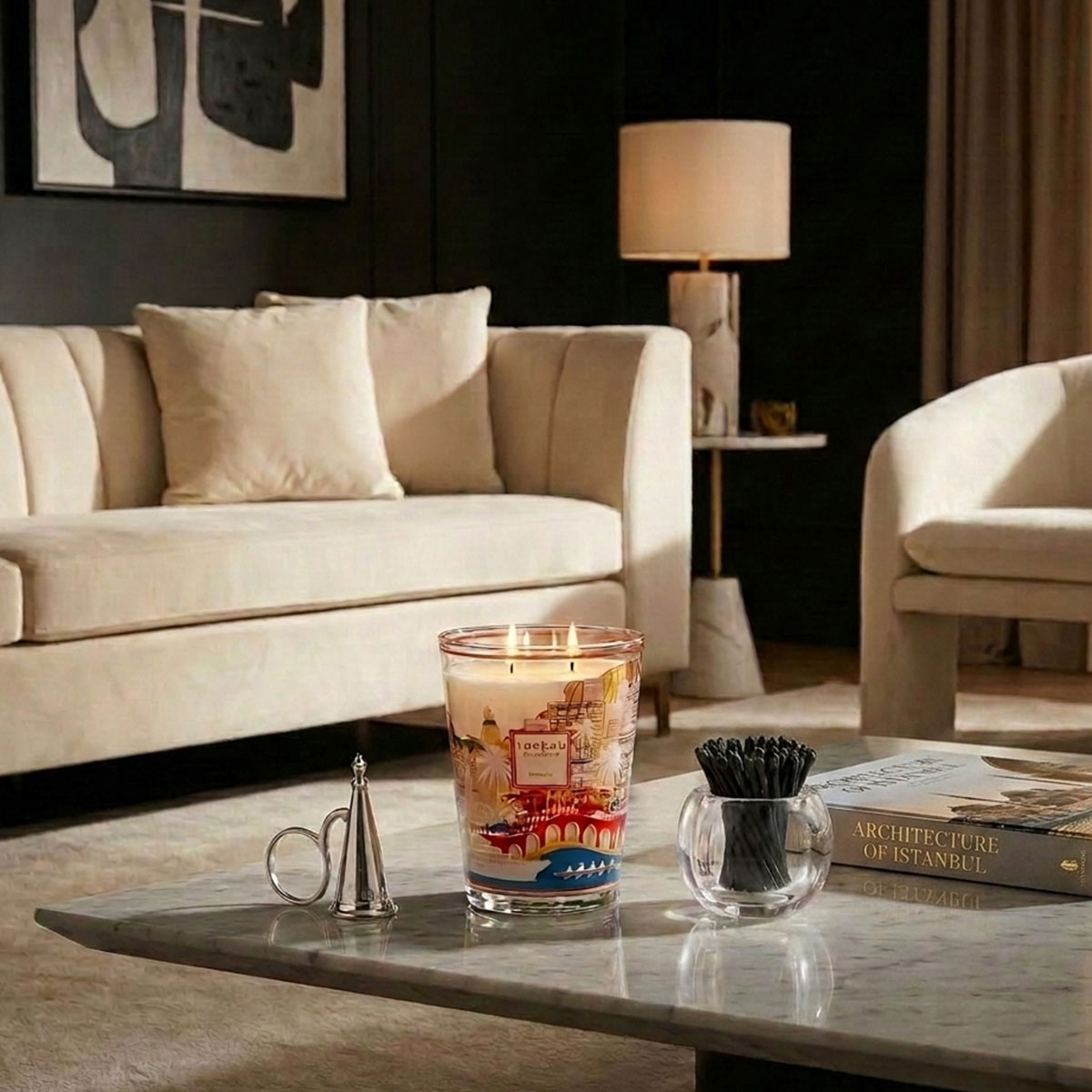 Living room with a beige sofa, coffee table, Baobab Monaco Candle, Match Pewter Snuffer and Tart by Taylor acrylic match holder and matches.