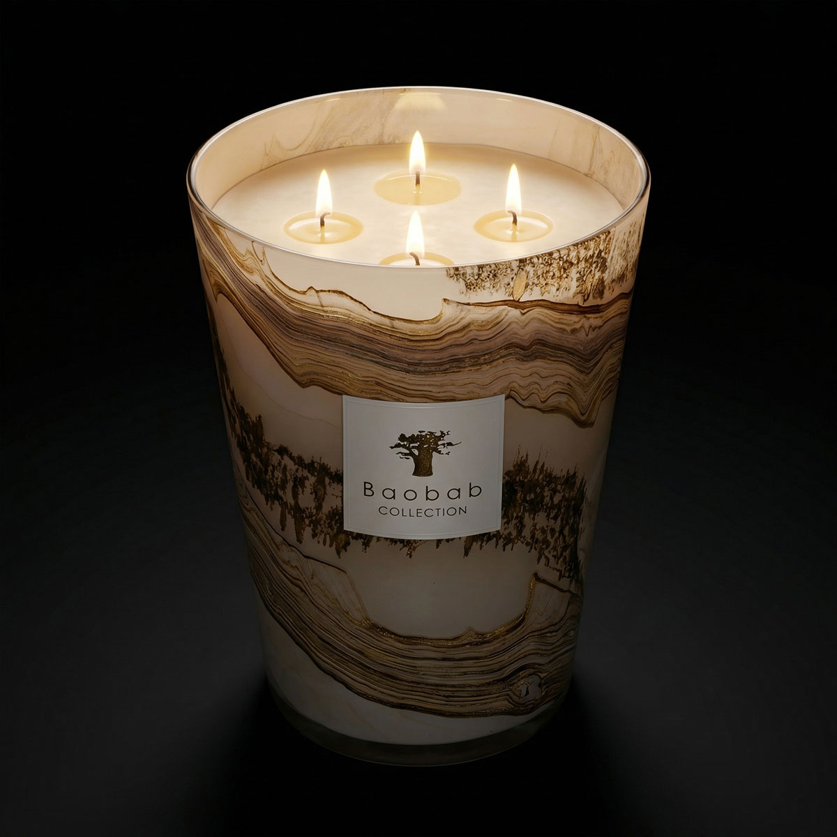 Lit candle from the Baobab Sand Collection' label on a dark background