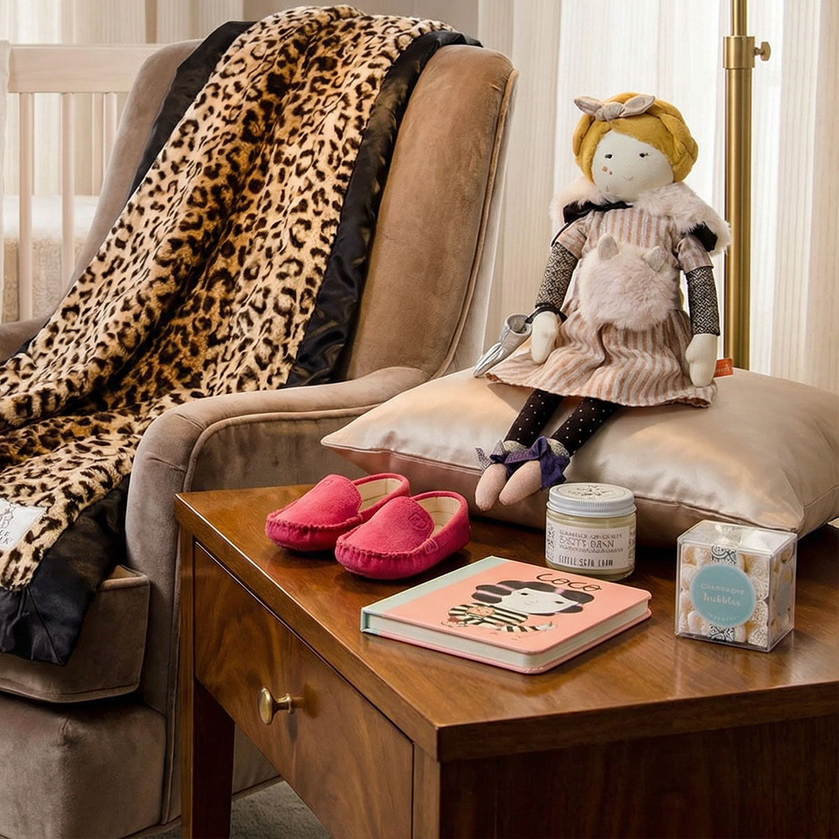 newborn baby gift box with little giraffe blanket-, doll, suede shoes, book in baby room.