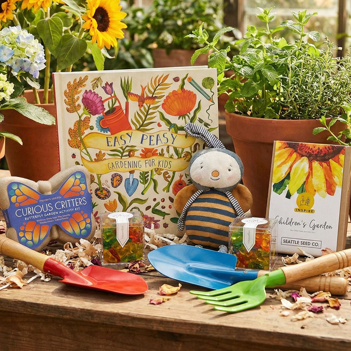 Gardening tools and children's book on a wooden surface with plants in the background
