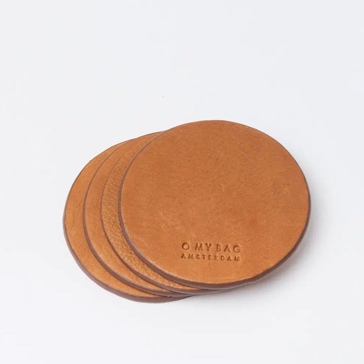 Set of three brown leather coasters with 'O MY BAG AMSTERDAM' branding on a white background