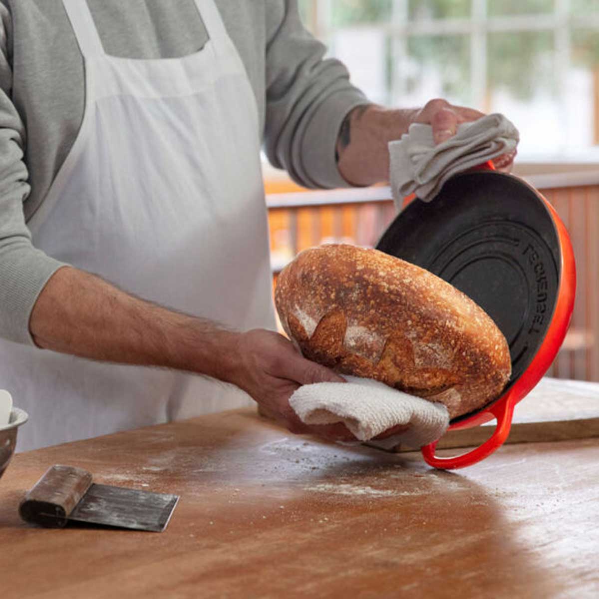 Le Creuset Bread Oven and Sourdough Bread Making Kit - man handling the bread