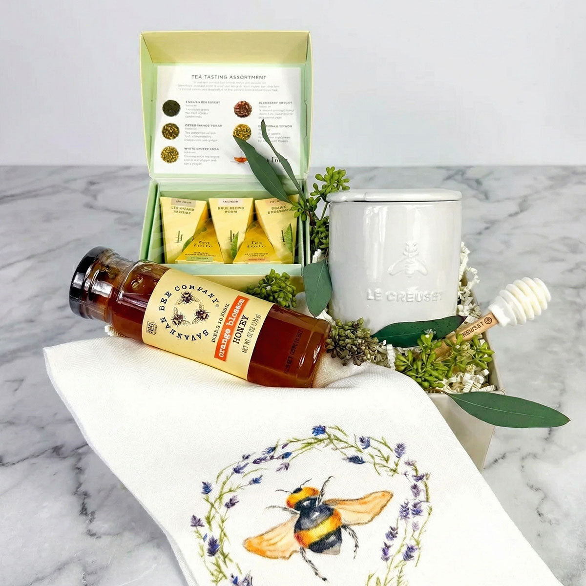 Le Creuset Honey Pot with Tea, Honey, dipper, and bee hand towel in a gift box.