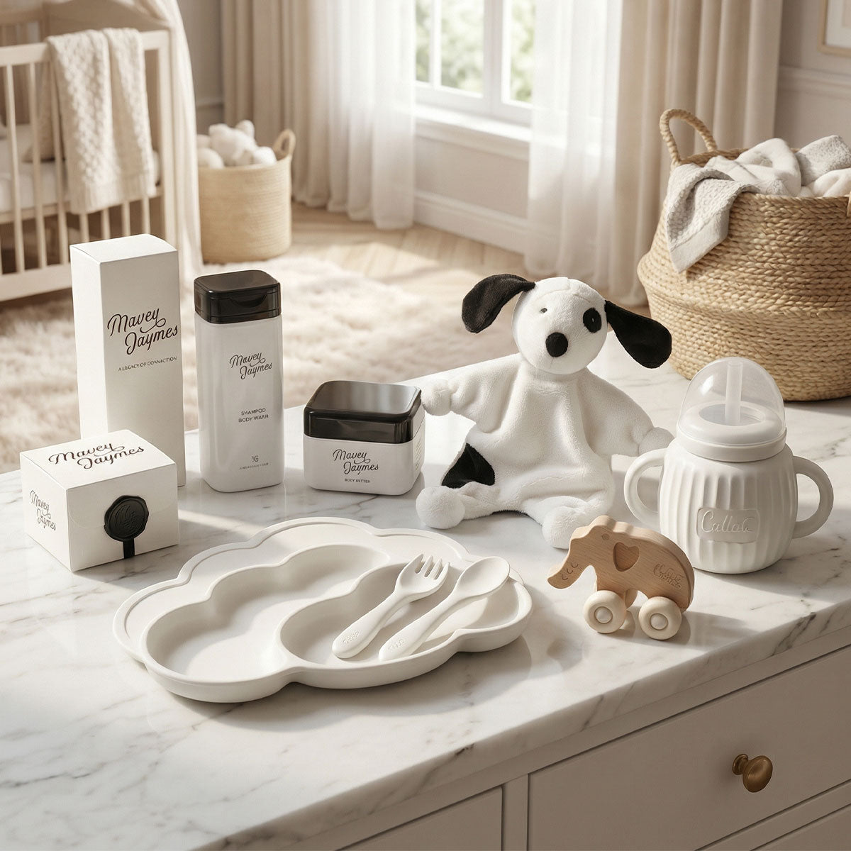 Luxury baby gifts with natural skincare, silicone feeding set, organic cotton toy, and elephant toy on a dresser in a baby's room.