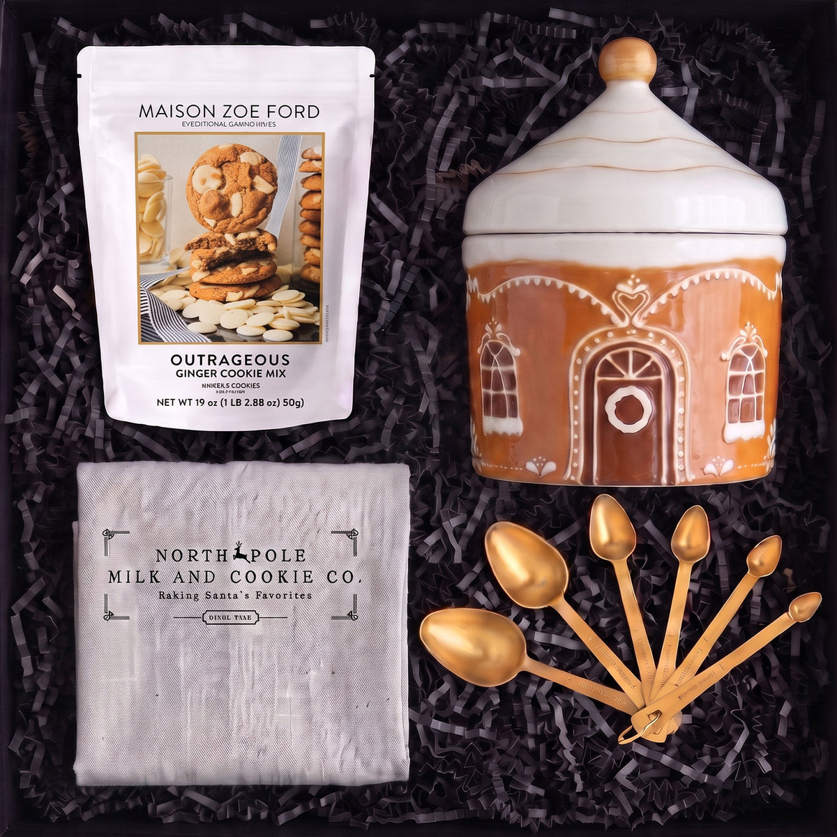 North Pole Cookie Company holiday gift box with gingerbread cookie jar, cookie mix, gold measuring spoons and festive apron