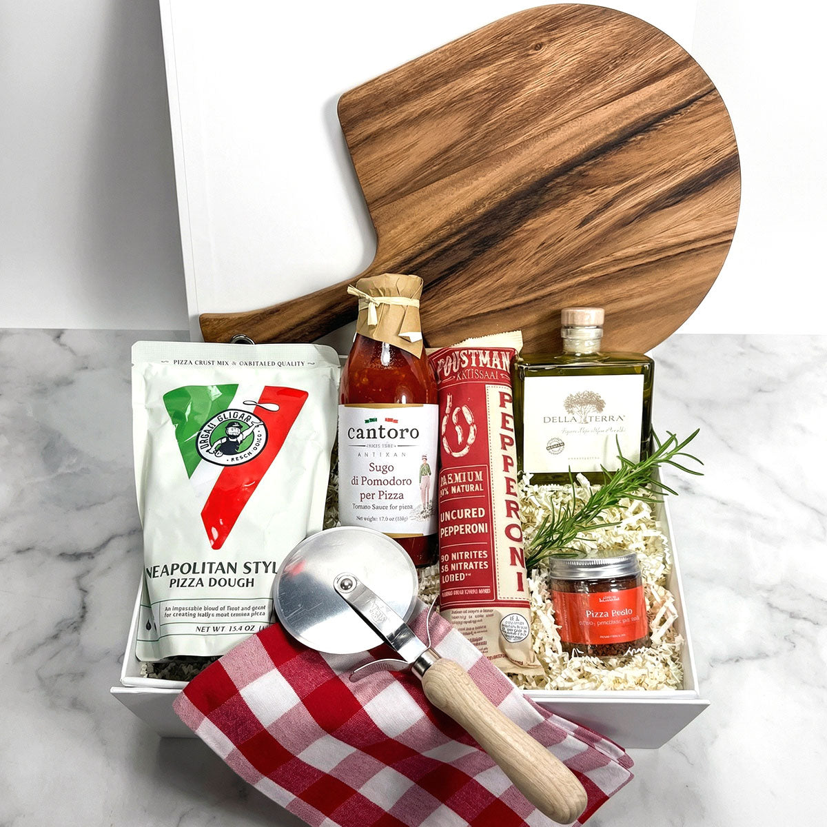 Gourmet Pizza Gift Box with pizza dough mix, sauce, pepperoni, olive oil, pizza paddle, and cutter.