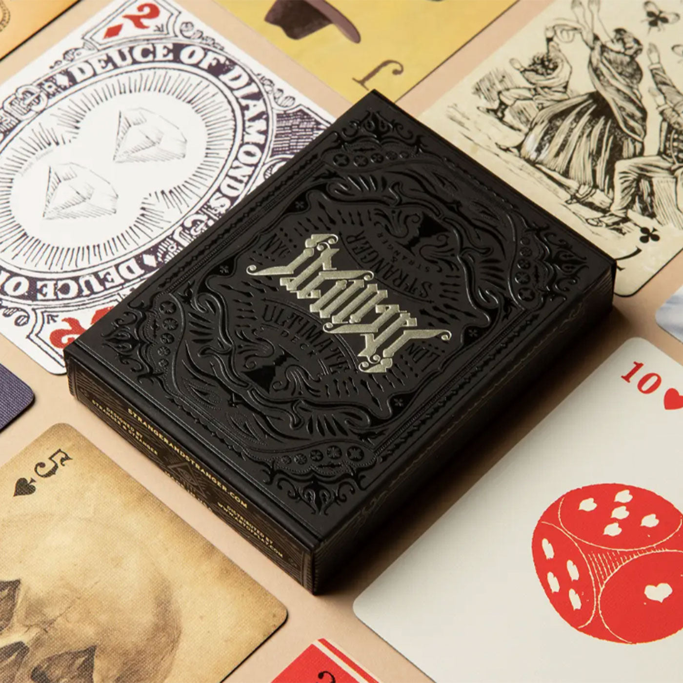 Playing cards - black case surrounded by printed playing cards.