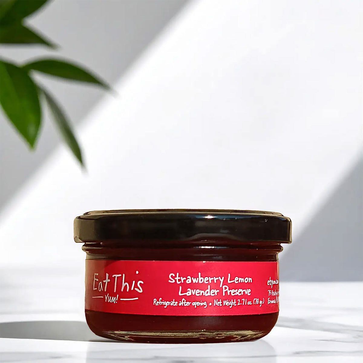 a jar of eat this strawberry lemon lavender reserve on a white background