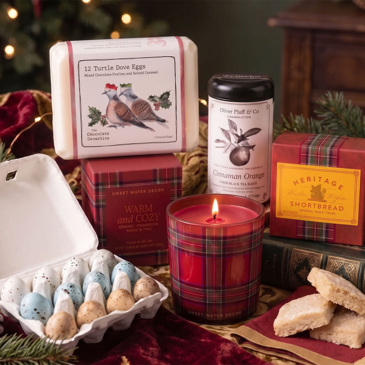 CHOCOLATE EGGS, TARTAN PLAID CANDLE, BOX OF HERITAGE SHORTBREAD AND A TIN OF TEA IN A FESTIVE BACKGROUND ON A TABLE