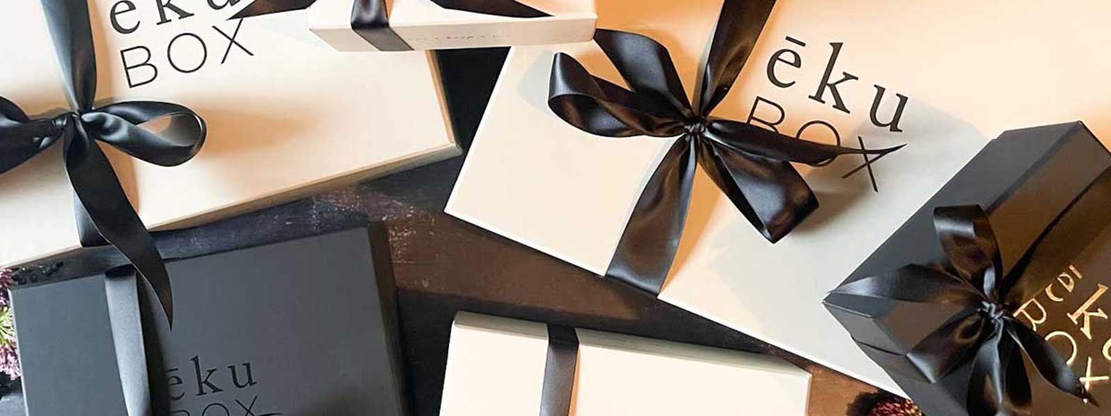 Curated ekuBOX luxury gift box featuring heritage brand products including Shinola and Le Creuset, styled for executive corporate gifting