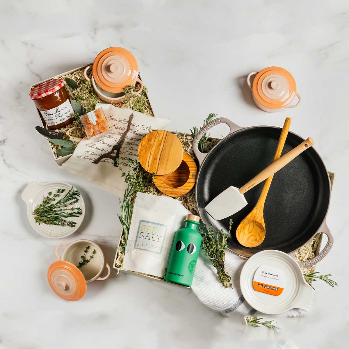 A Le Creuset cooking gift set featuring coordinated cookware and kitchen tools, beautifully presented as a retirement gift.