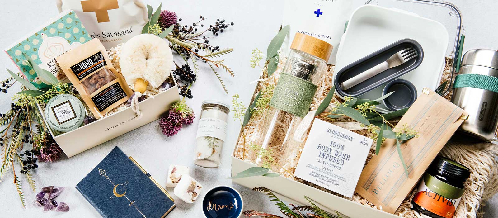 Spa and wellness gift boxes beautifully packaged with luxury self-care items, arranged with fresh flowers along the base, ideal for relaxation, self-care, and thoughtful gifting.