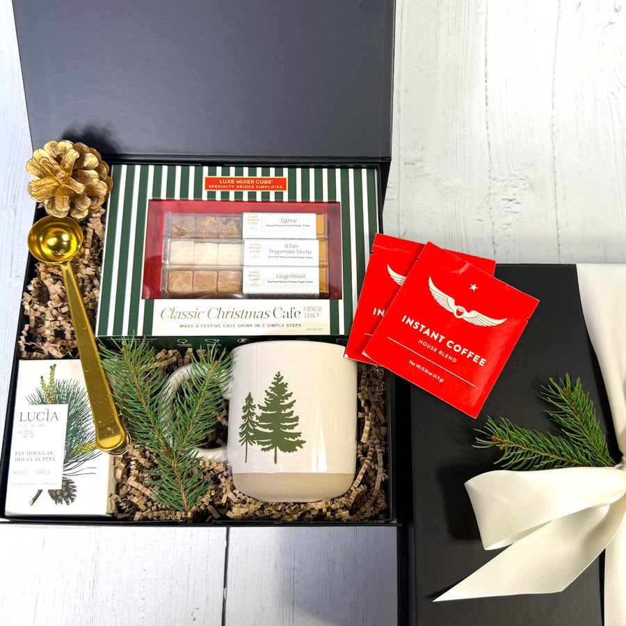 Gift set with mug, candle, and tea, and flavored sugar cubes in a gift box 包 on a white surface