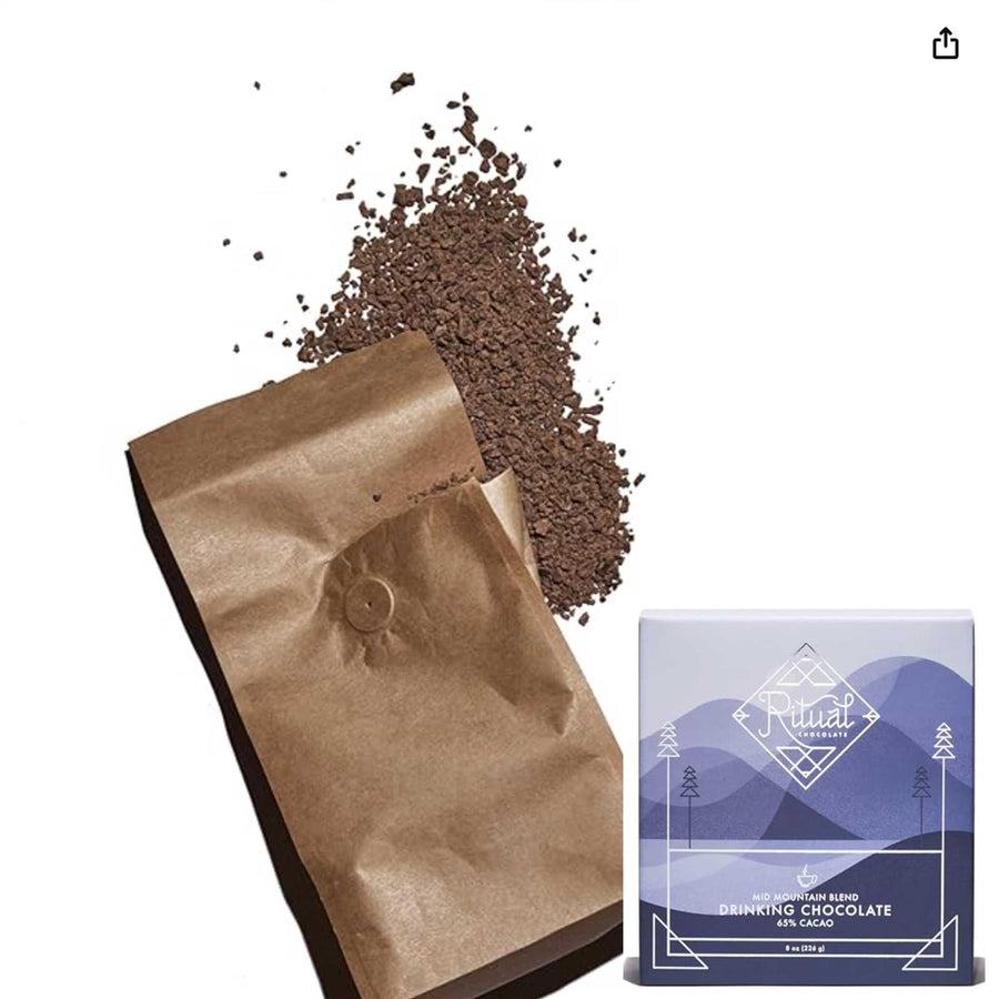 Open brown bag of drinking chocolate powder with a blue package (the drinking chocolate container) on a white background