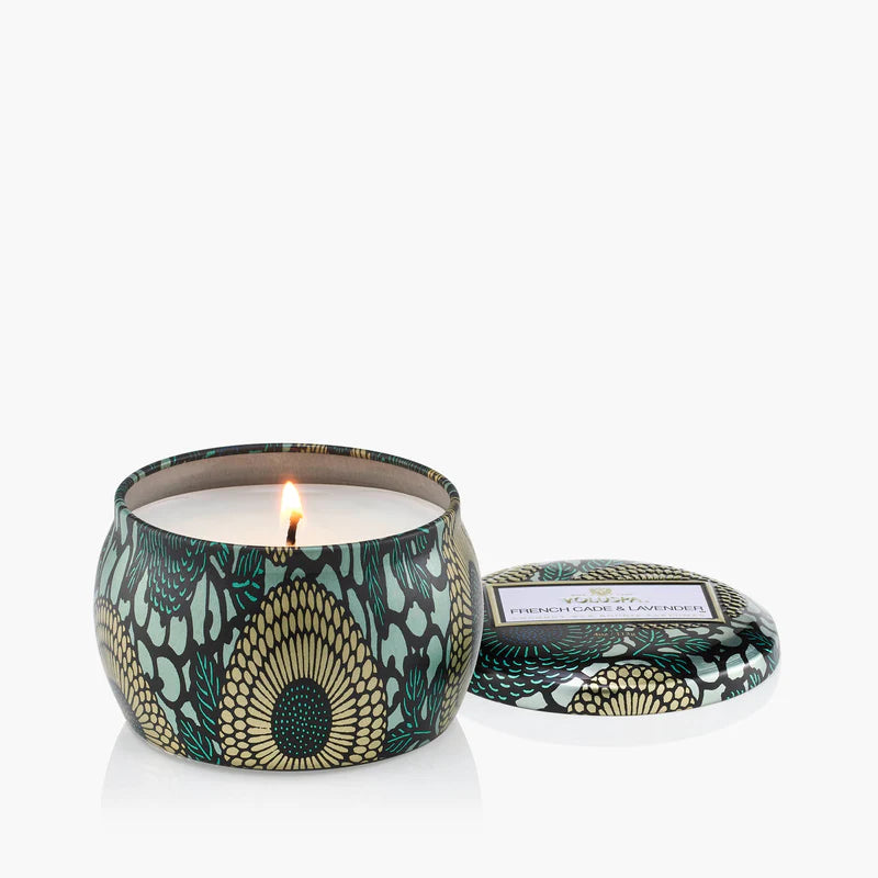 Decorative candle with a patterned lid on a white background by Voluspa