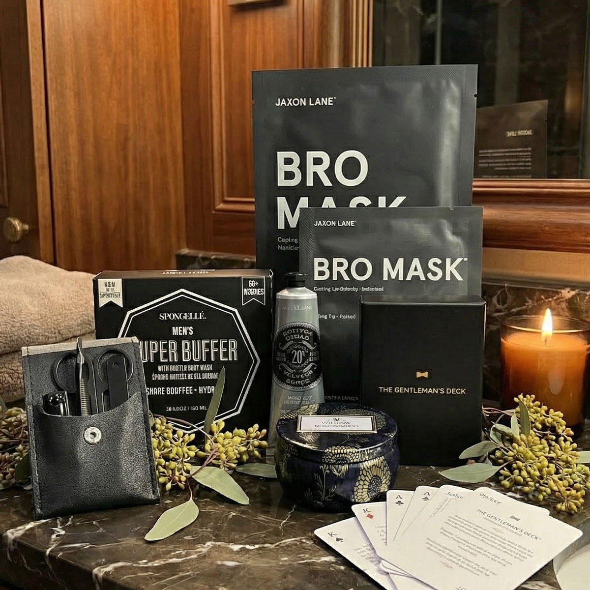Men's Grooming products 'Bro Mask' and 'Super Buffer' on a marble surface with a candle and cards in the background.