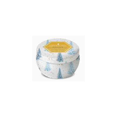 Candle in a decorative tin with a winter forest design on a white background