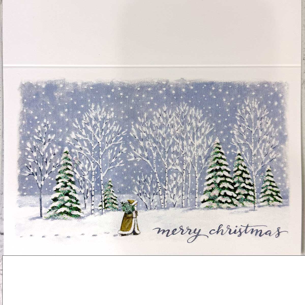 Winter scene with trees and a person in the snow, 'merry christmas' card on a white background