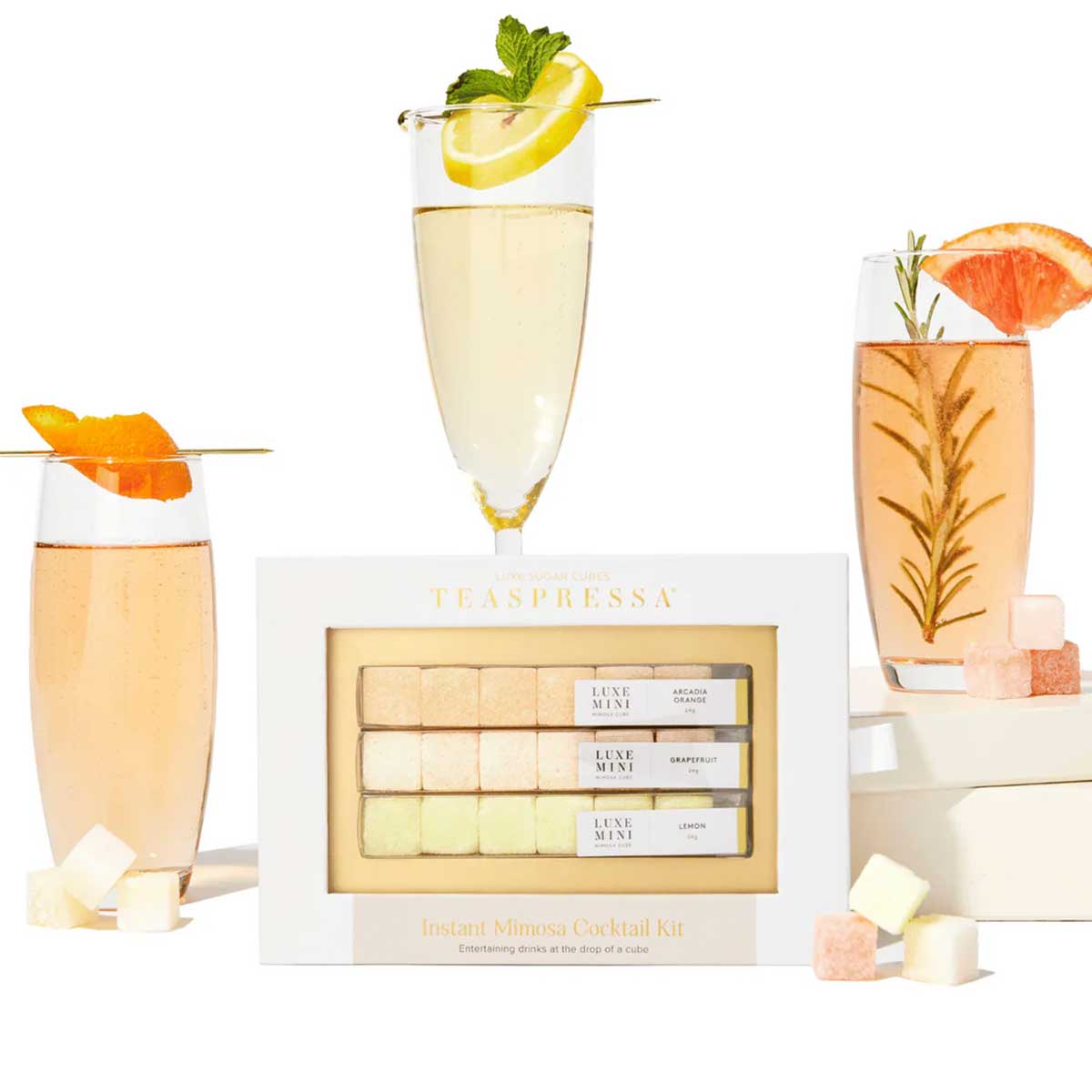 Teapresso beverage kit with cocktails and garnishes on a white background