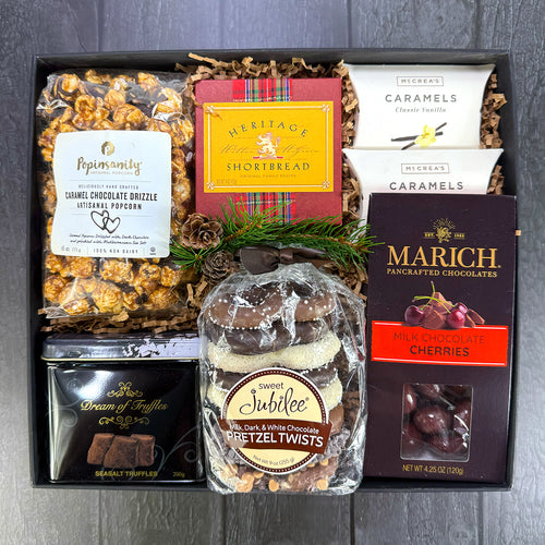 Gourmet snack gift box with caramel chocolate drizzled popcorn, shortbread, caramels, marich, chocolate pretzels, and dream of truffles