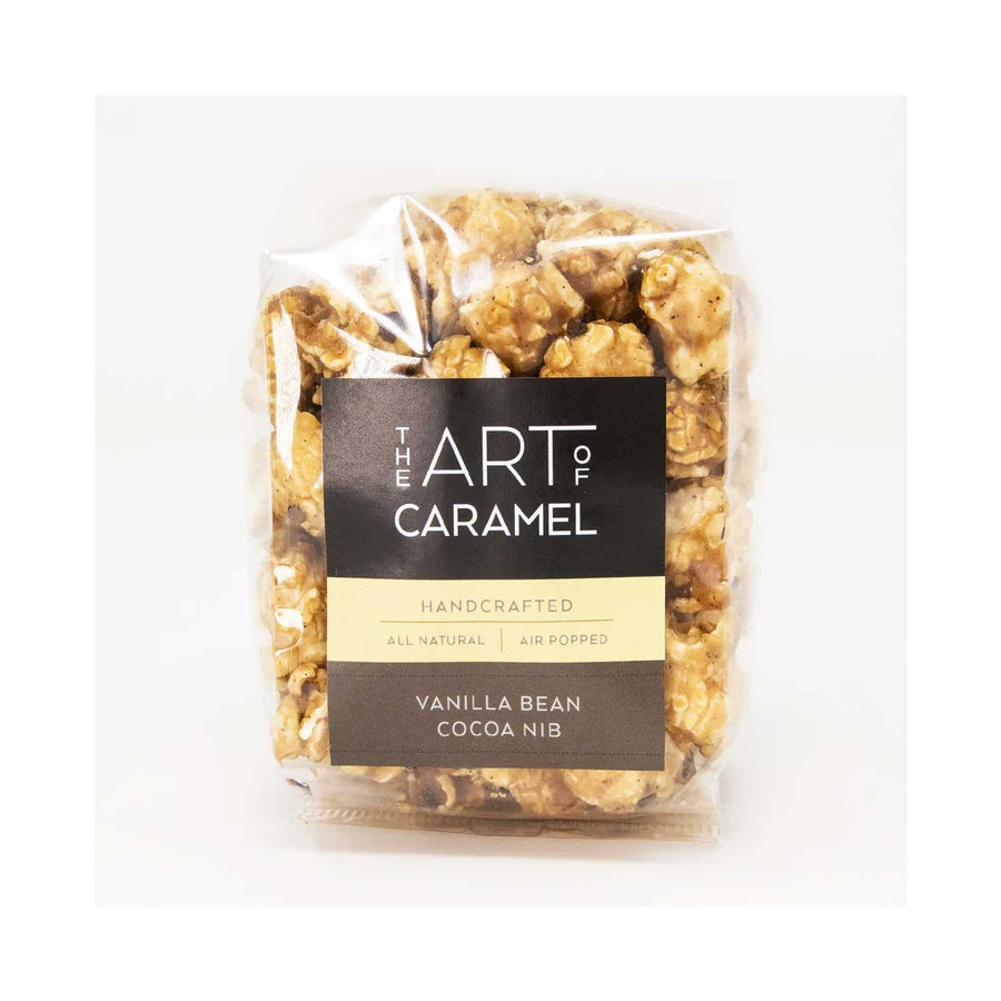 mini bag of artisan made popcorn on a grey background
