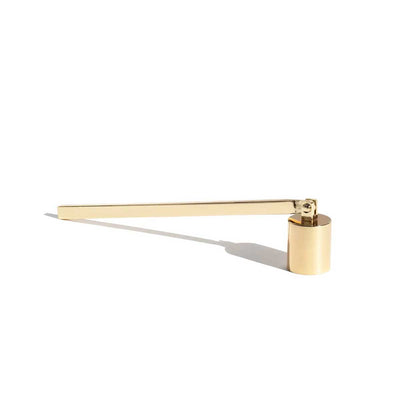 Gold candle snuffer on a white background