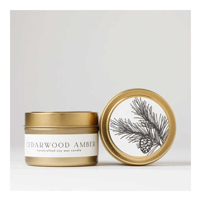 Cedarwood Amber candle with gold lid on a white background