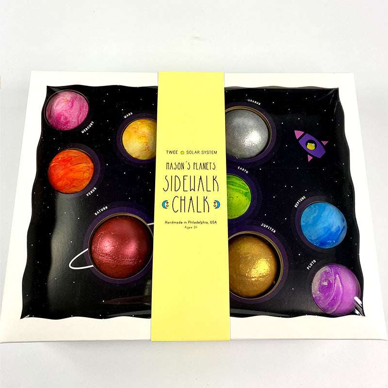 box of different colored planet-themed chak spheres on a white background