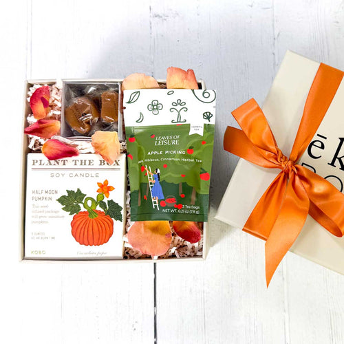 Gift box with 'Plant the Box' candle and tea, and caramels featuring autumn-themed packaging in an eku box.