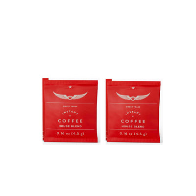 Two red instant coffee packets on a white background