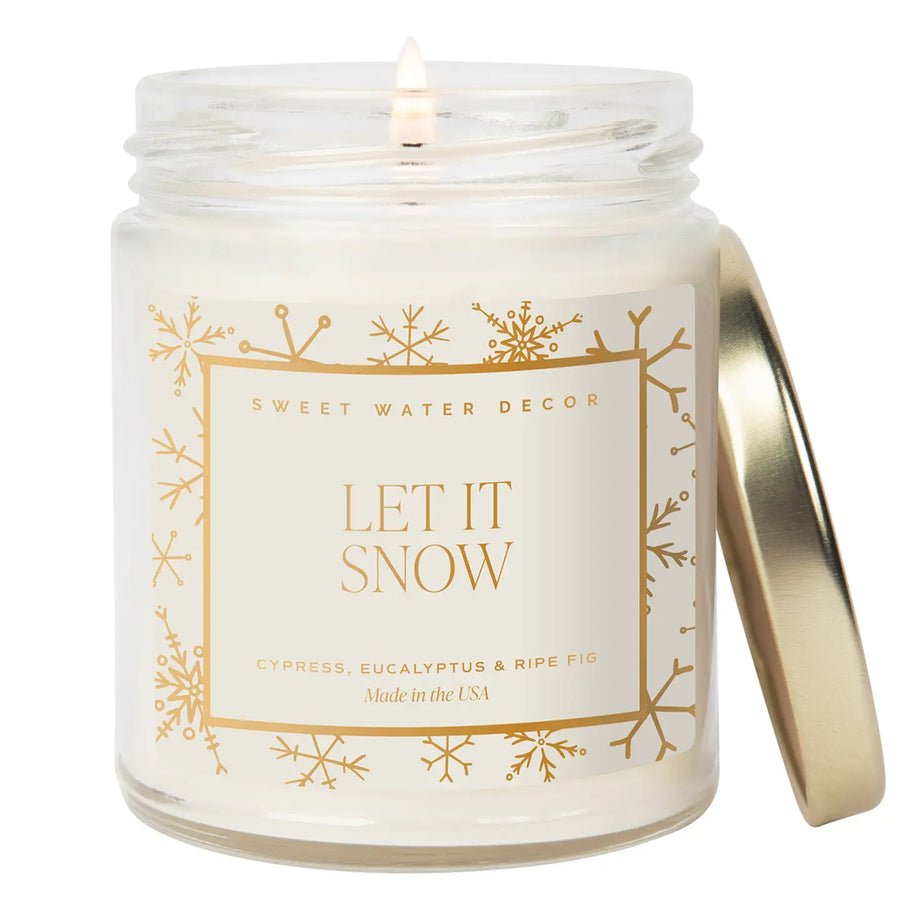 Let it Snow Candle in a glass jar with a snowflake label on a white background