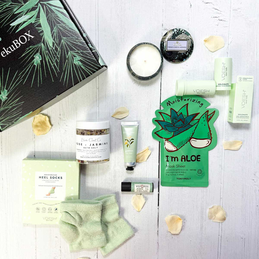 Assorted body and foot care and wellness products on a white surface with a box labeled &