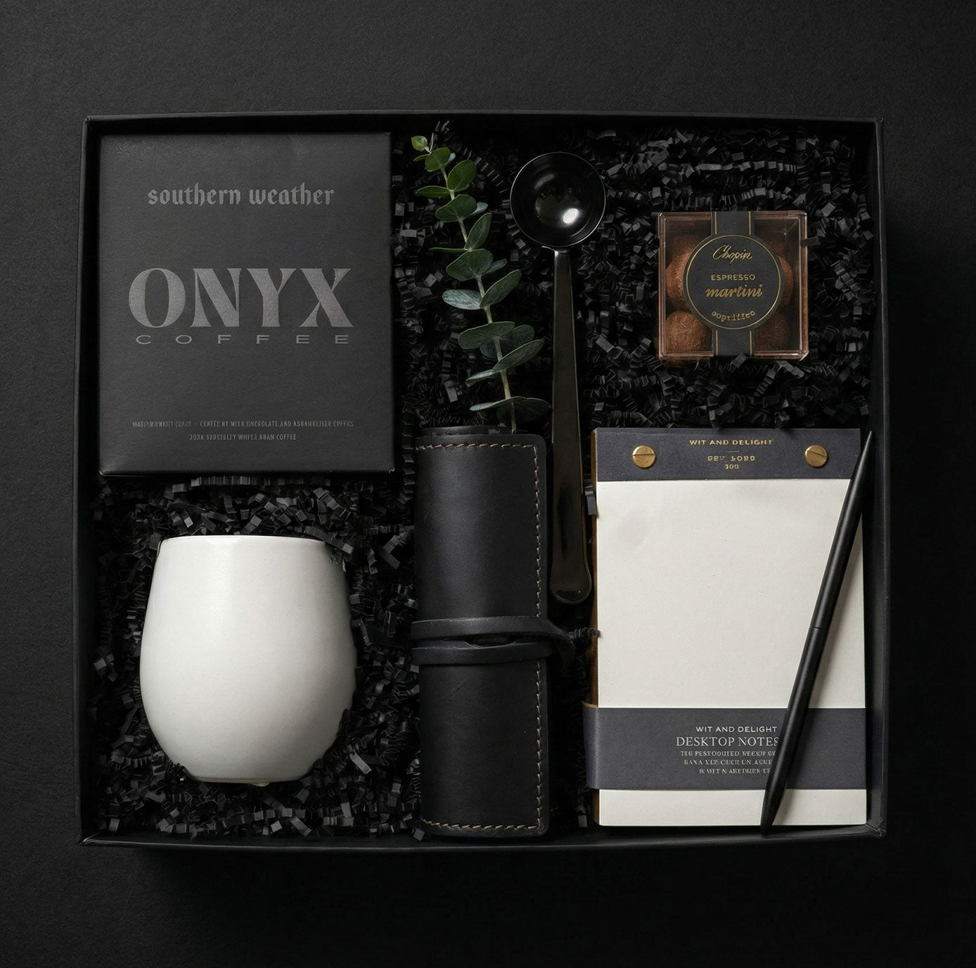 A luxury corporate gift box with Onyx coffee and desk accessories, showcasing our bespoke executive gifting service.