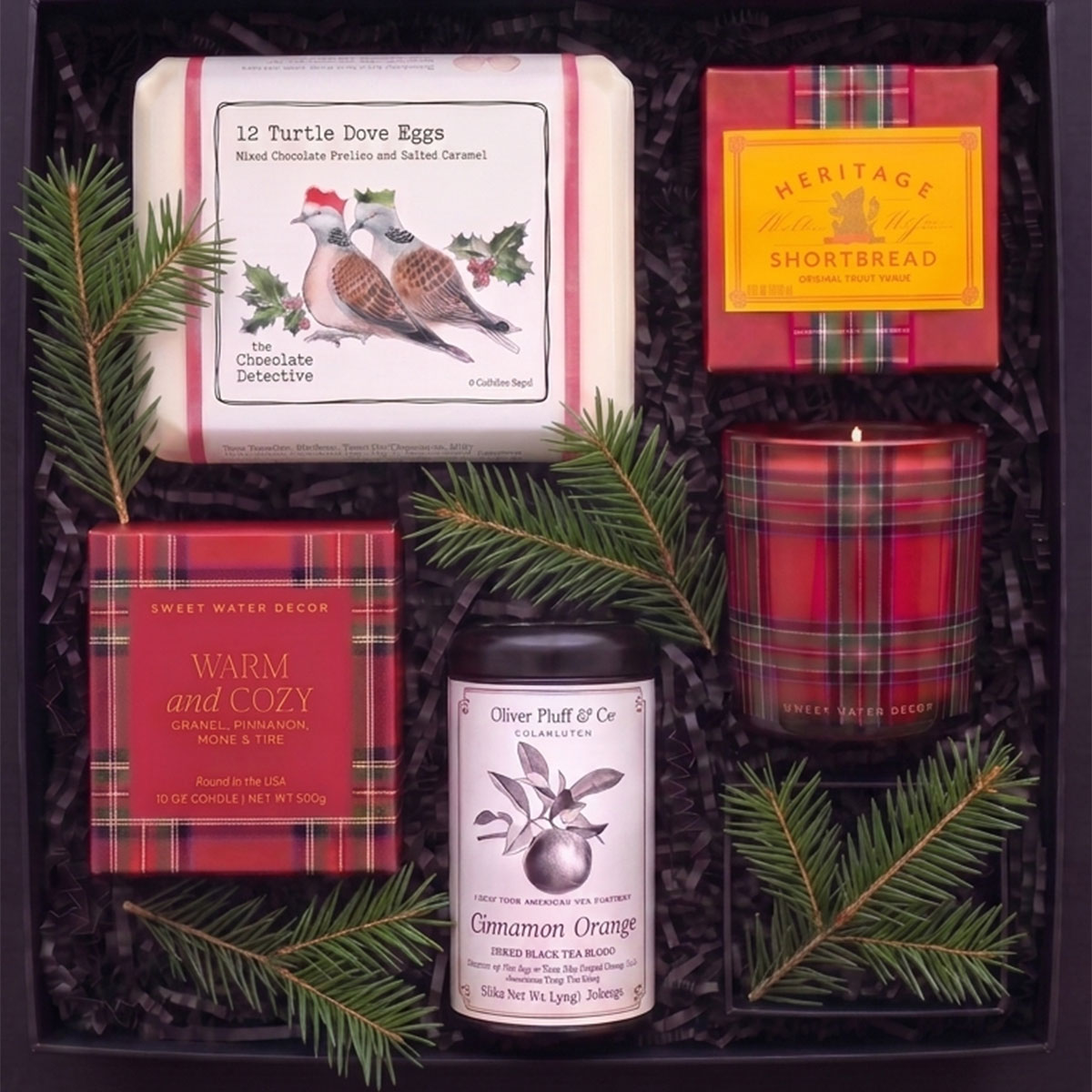 holiday gift box featuring chocolate eggs, heritage shortbread, cinnamon orange tea and a warm and cozy holiday candle.
